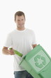Man throwing glass bottle in the recycling bin