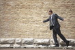Man in suit walking on ramp by wall