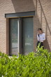 Young woman smoking a cigarette outside building