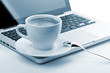 Cappuccino cup on laptop. Toned Cappuccino cup on laptop. Toned