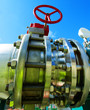Industrial zone, Steel pipelines and valves against blue sky Industrial zone, Steel pipelines and valves against blue sky