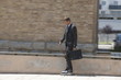 Businessman in suit inline skating