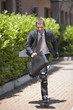 Businessman in suit inline skating
