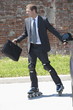 Businessman in suit inline skating