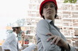 Woman with hardhat and man on walky talky at construction site