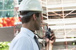 Man with hardhat and walky talky radio at construction site