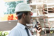 Man with hardhat and walky talky radio at construction site