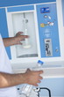 Closeup of man's hands filling milk bottle at cooler