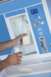 Closeup of man's hands filling milk bottle at cooler