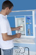 Man filling milk bottle at cooler