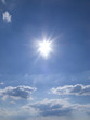 Sun in blue sky with clouds
