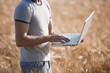 Photo: Man's torso with laptop computer in wheat field Man's torso with laptop computer in wheat field