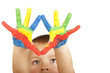 Smiling child with painted hands (focus on hands) Smiling child with painted hands (focus on hands)