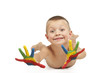 Smiling child laying down with painted hands Smiling child laying down with painted hands