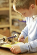 Young boy fixing skateboard