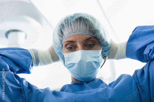 Photo: Surgeon wearing surgical mask in operating room Surgeon wearing surgical mask in operating room