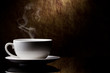cup of coffee with cinnamon on a old stone background.