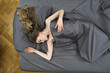A young woman sleeping in a bed