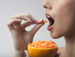A woman taking vitamin c tablets