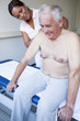 A massage therapist treating a senior man