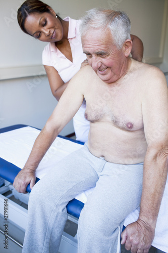 Photo: A massage therapist treating a senior man A massage therapist treating a senior man