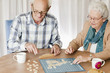 A senior couple playing a board game together