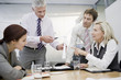 Four businesspeople colleagues discussing a wind turbine project