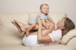 Child and mother playing on the sofa Child and mother playing on the sofa
