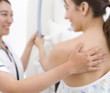 Radiologist helping patient with mammogram