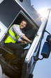 Truck driver closing door of semi-truck