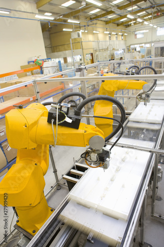 Photo: Robotic arms working on factory assembly line Robotic arms working on factory assembly line