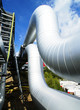 Industrial zone, Steel pipelines and valves against blue sky
