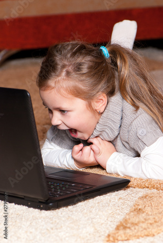 Photo: Portrait of a little girl with a laptop Portrait of a little girl with a laptop