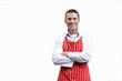 Smiling butcher in apron with arms crossed