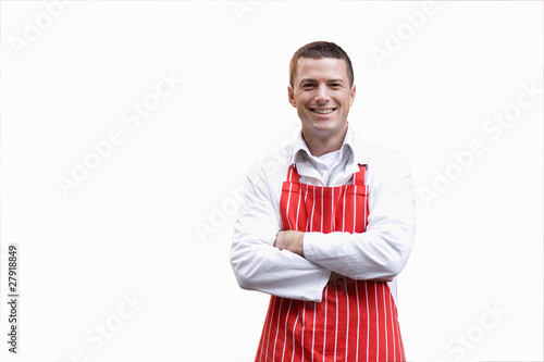 Photo: Smiling butcher in apron with arms crossed Smiling butcher in apron with arms crossed