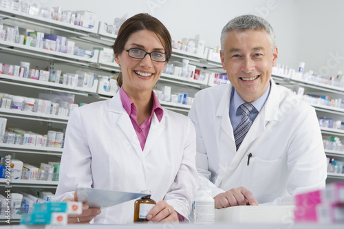 Photo: Pharmacists filling bottle with medicine in pharmacy Pharmacists filling bottle with medicine in pharmacy