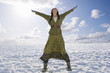 Exhilarated woman standing in snowy field