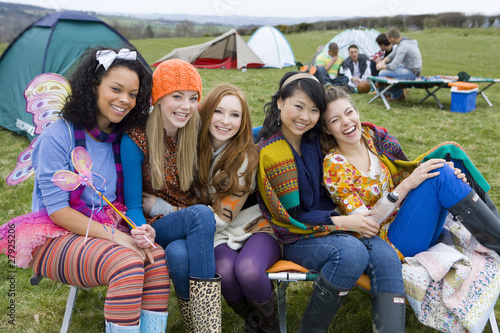 Photo: Laughing friends camping and attending outdoor festival Laughing friends camping and attending outdoor festival