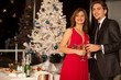 Happy young couple with champagne glasses at christmas