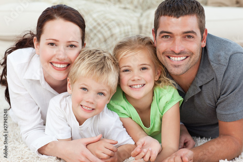Photo: Portrait of a smiling family in the carpet Portrait of a smiling family in the carpet