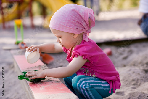 Photo: little girl in sandbox little girl in sandbox