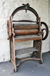 A rusty old hand operated printing press machine.