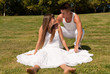 young couple happy sitting on grass white love relationship
