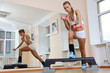 Girl on step hold dumbbells  in fitness gym