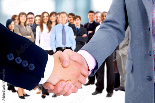 Photo: handshake isolated on business background handshake isolated on business background