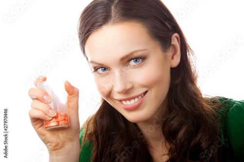 Photo: Portrait of smiling woman showing bottle with pills, isolated Portrait of smiling woman showing bottle with pills, isolated