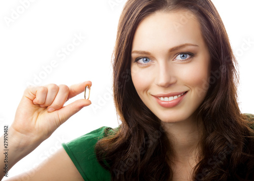 Photo: Portrait of woman showing Omega 3 fish oil capsule, isolated Portrait of woman showing Omega 3 fish oil capsule, isolated