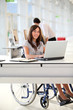 Businesswoman in wheelchair working in the office