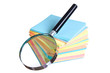 magnifying glass and a stack of paper magnifying glass and a stack of paper