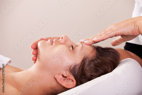 Photo: Young beautiful woman getting facial massage Young beautiful woman getting facial massage